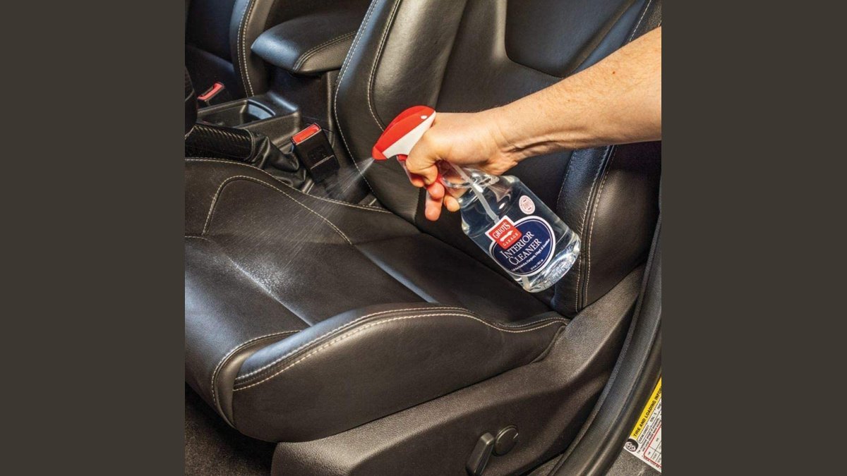 Clean black leather car seats illuminated by soft natural light for interior maintenance.