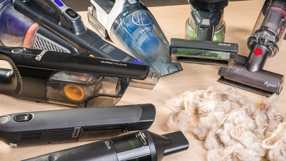 Cordless car vacuum for pet hair sitting on a vehicle seat.