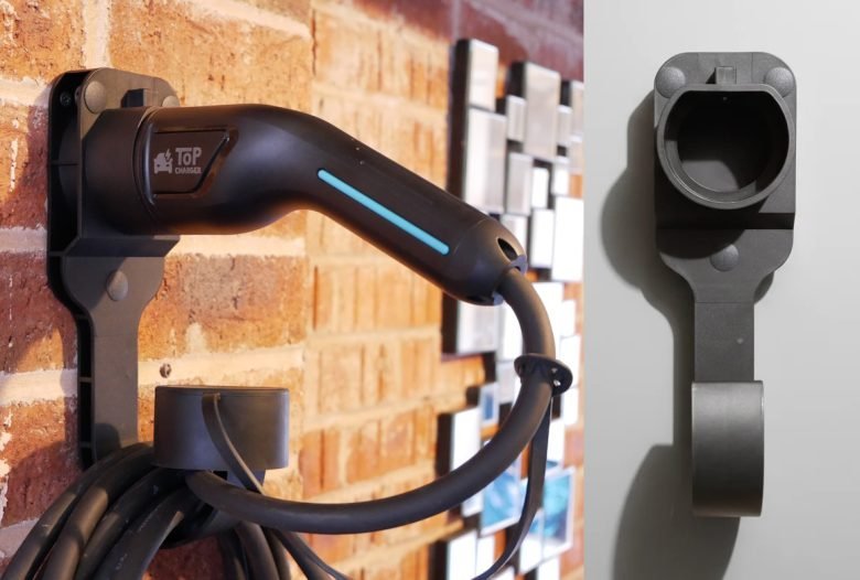 Neatly organized EV charging cable on a wall mount in a clean garage.
