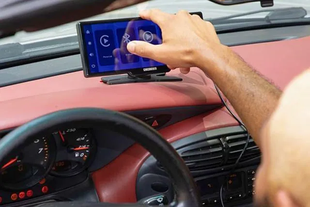 A premium wireless carplay adapter plugged into a vehicle USB port.