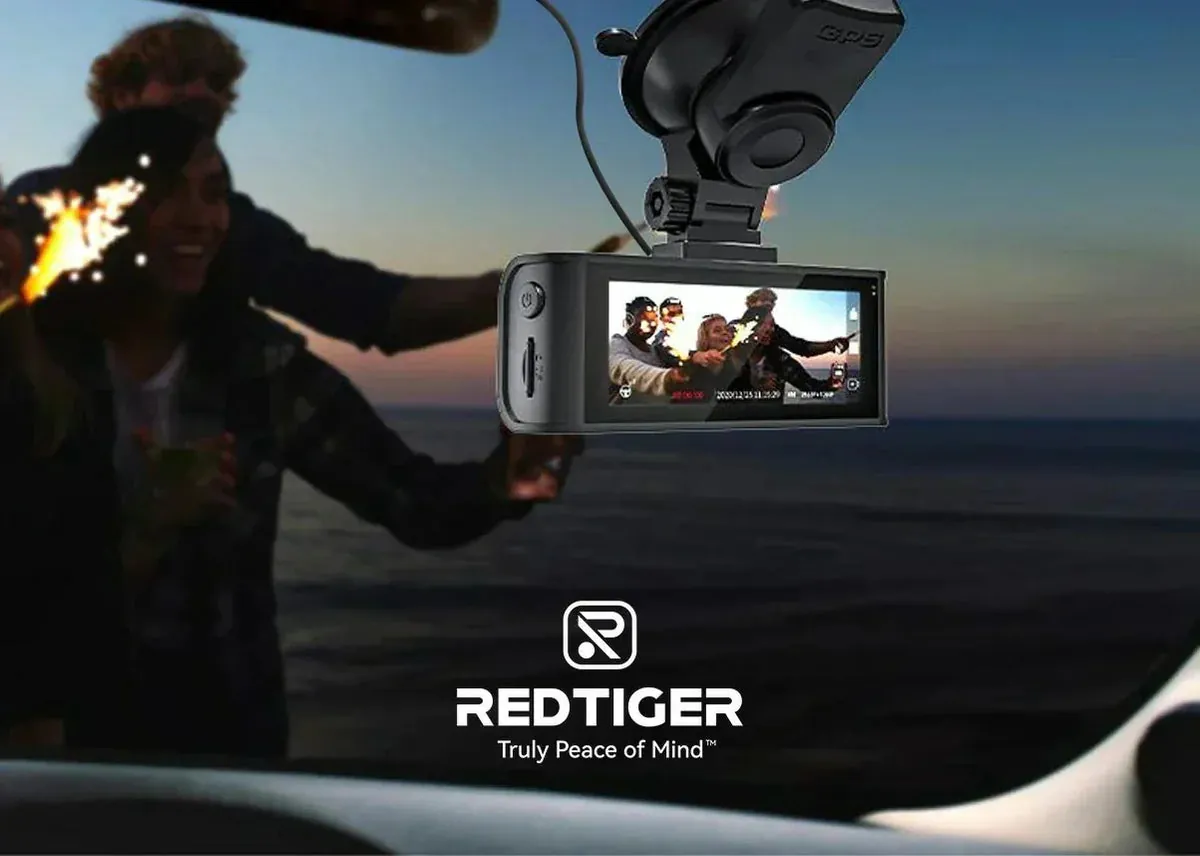 Small dash cam hidden behind a rearview mirror at night