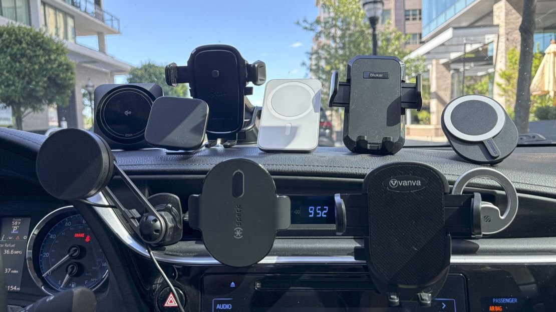 A smartphone secured in a car phone holder on a modern dashboard.