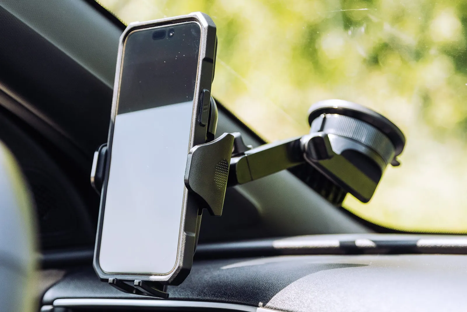 Three different types of car phone holders displayed together on a table.