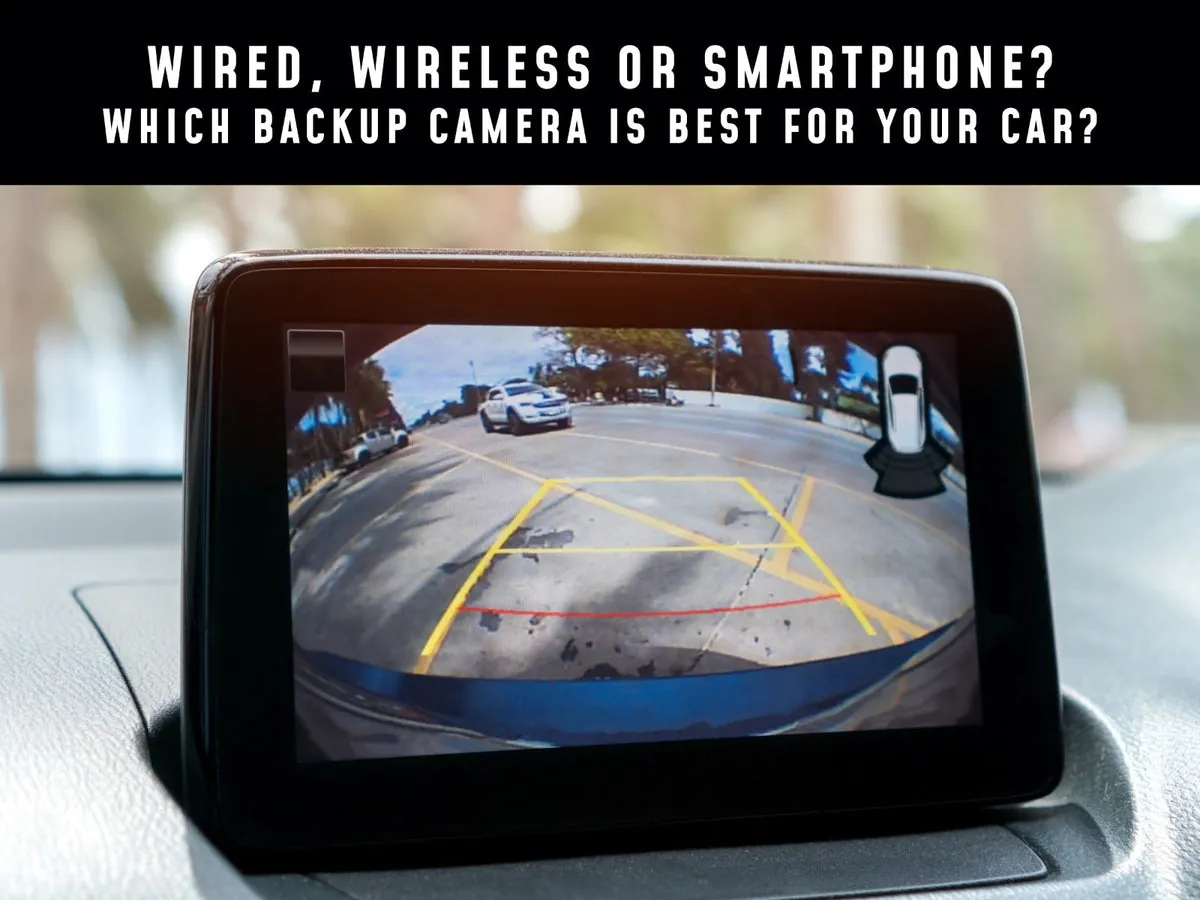 Tools and wireless backup camera parts laid out inside an open car trunk.