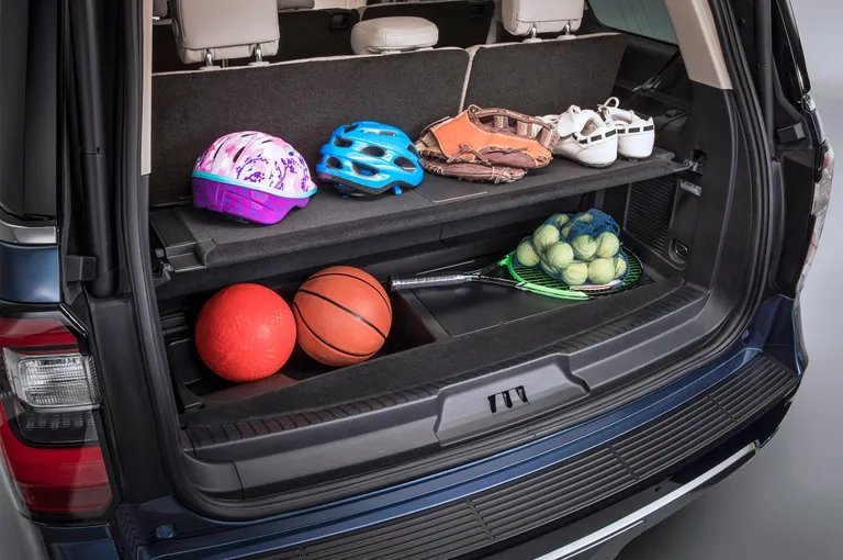 Various SUV trunk organizers displayed together in a clean vehicle cargo area